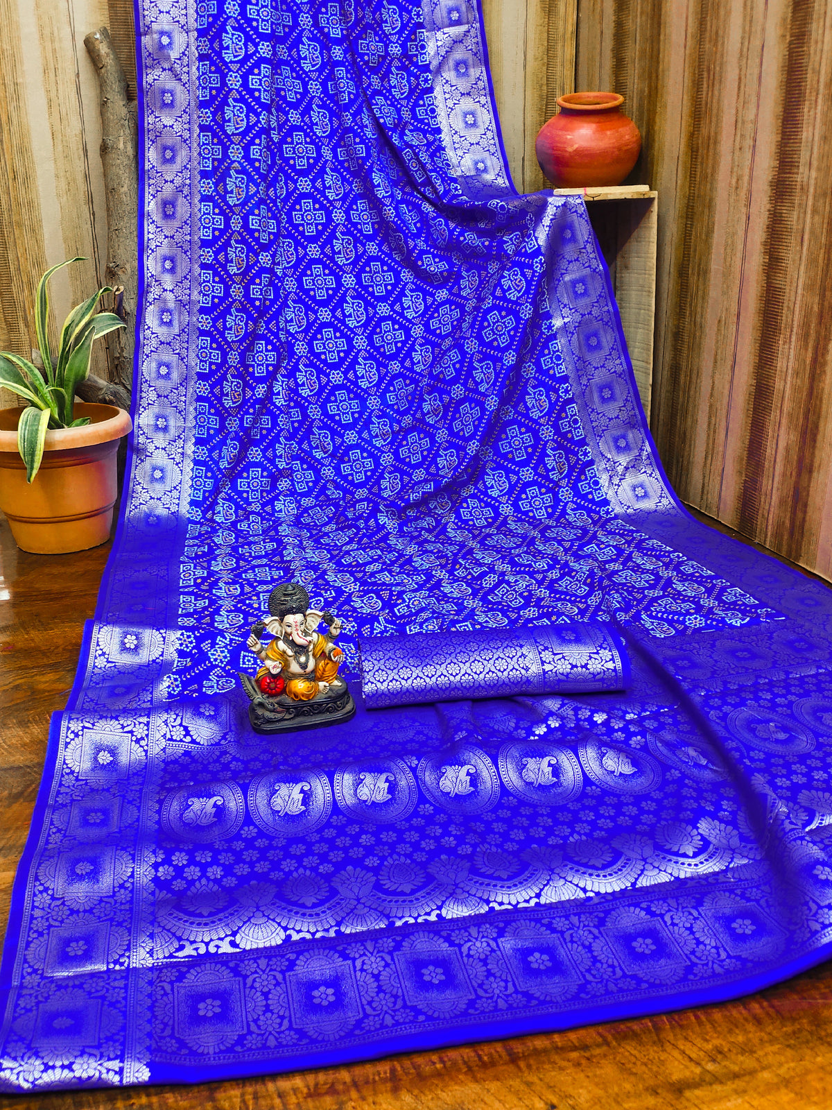 Blue saree with white patterns on a wooden surface
