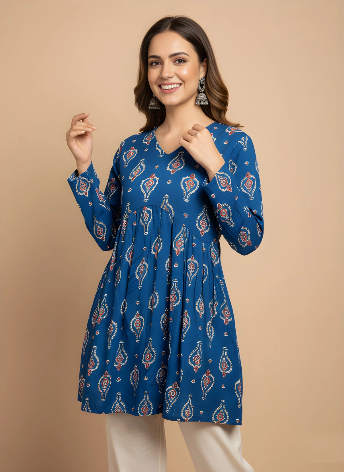Woman wearing a blue patterned dress against a beige background