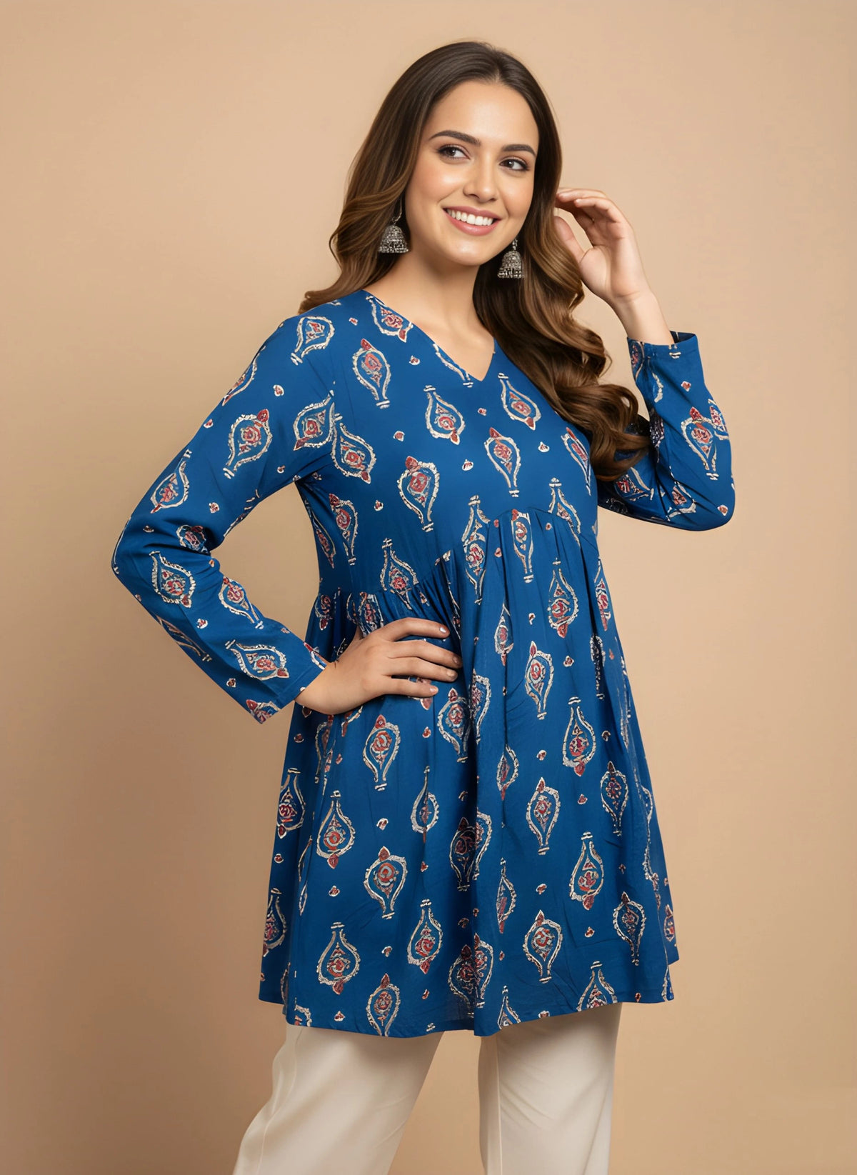 Woman wearing a blue patterned dress against a beige background