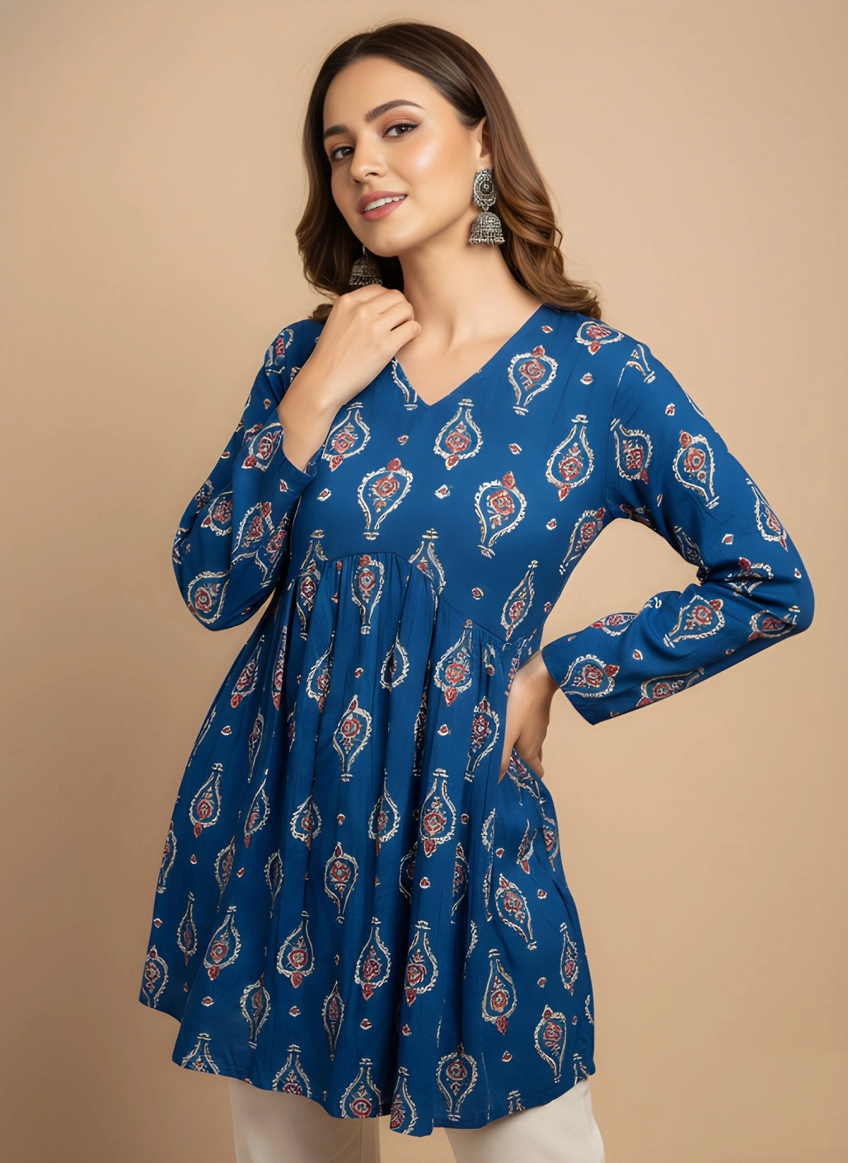Woman wearing a blue patterned dress against a beige background