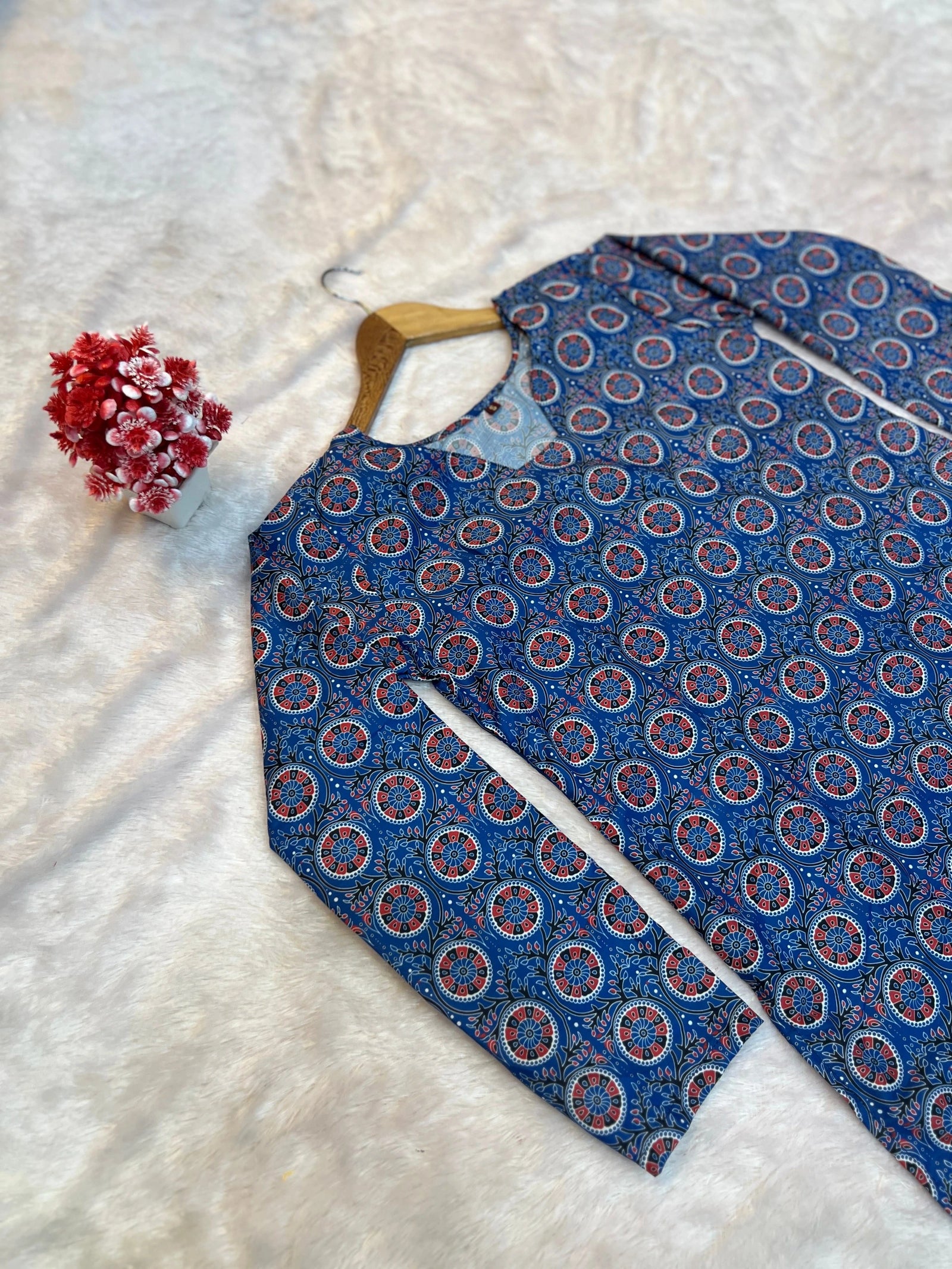 Blue patterned shirt on a hanger with a white background