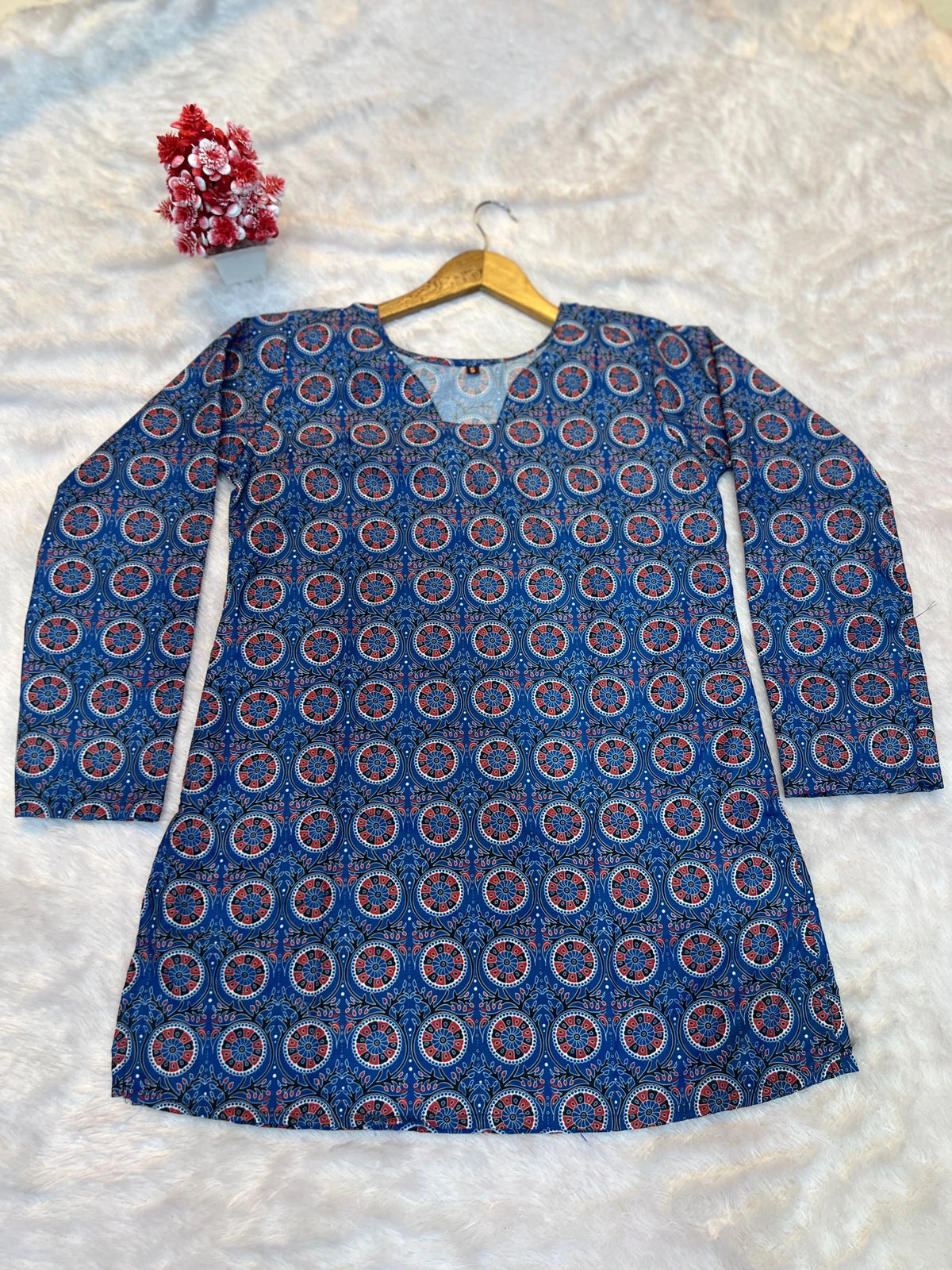 Blue patterned dress on a hanger against a white background
