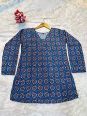 Blue patterned dress on a hanger against a white background