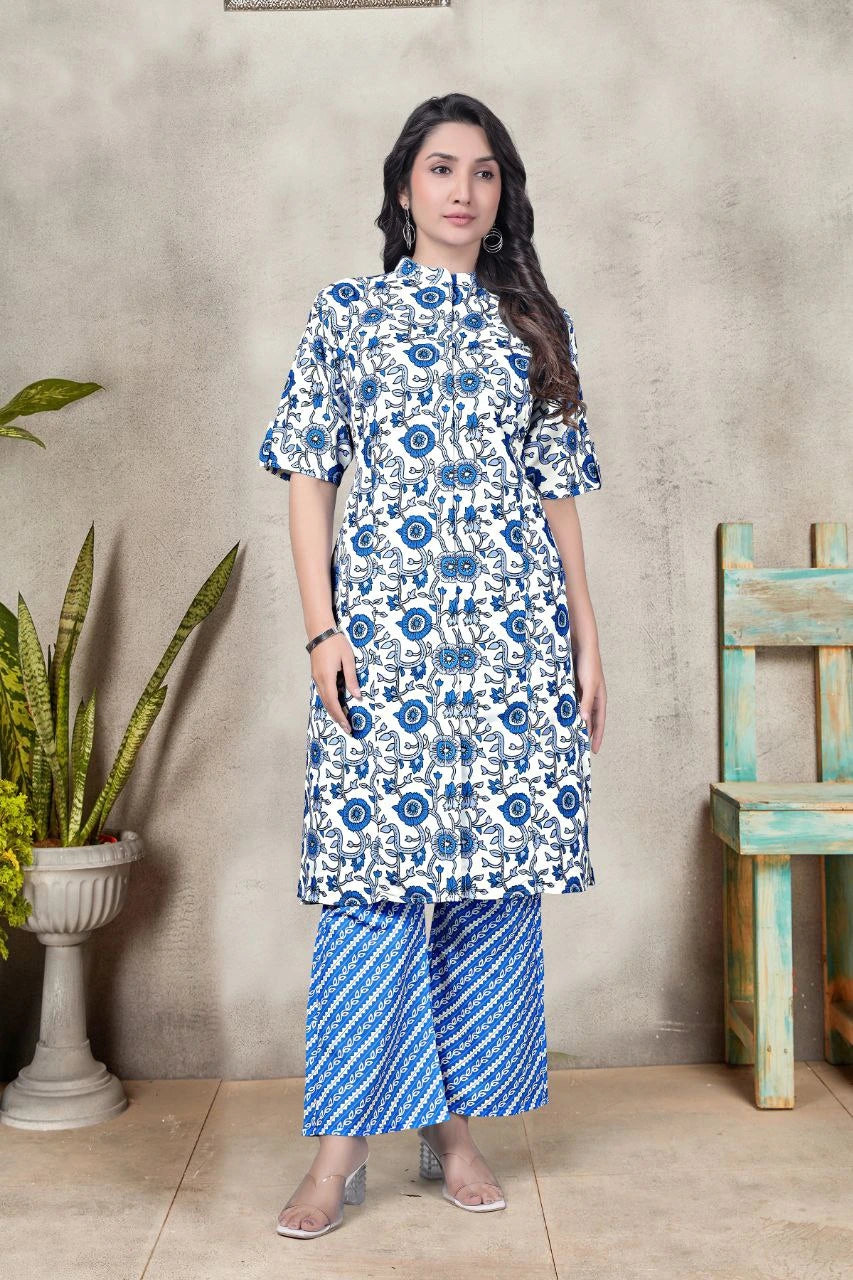 Woman wearing a blue and white floral dress with matching pants against a neutral background.