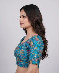 Woman wearing a blue floral blouse against a white background
