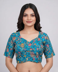 Woman wearing a blue floral blouse against a plain background