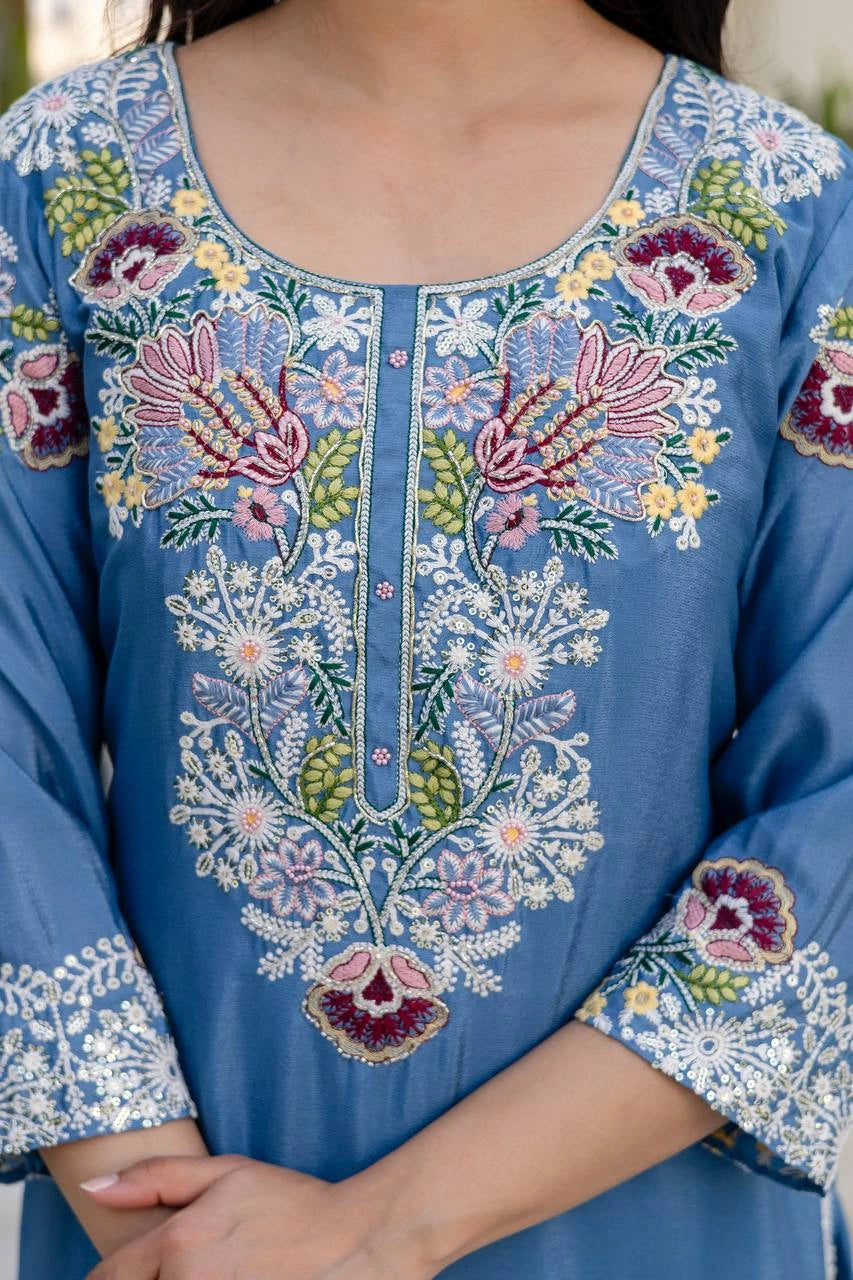 Close-up of a blue embroidered garment with floral patterns