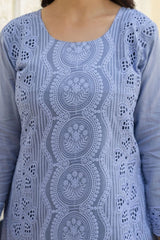 Blue patterned top with intricate designs on a plain background
