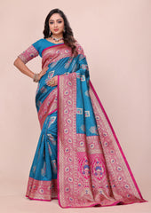 Woman wearing a blue and pink saree with a beige background