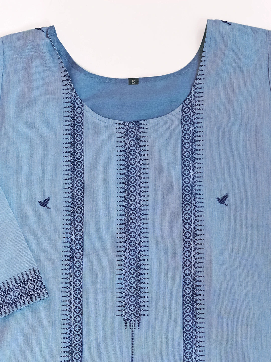 Light blue dress with intricate black embroidery on a white background