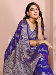 Woman wearing a purple saree with a beige background