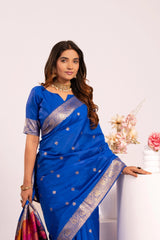 Woman wearing a blue saree with gold border against a white background