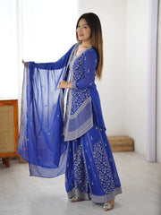 Woman in a blue traditional outfit with a white background