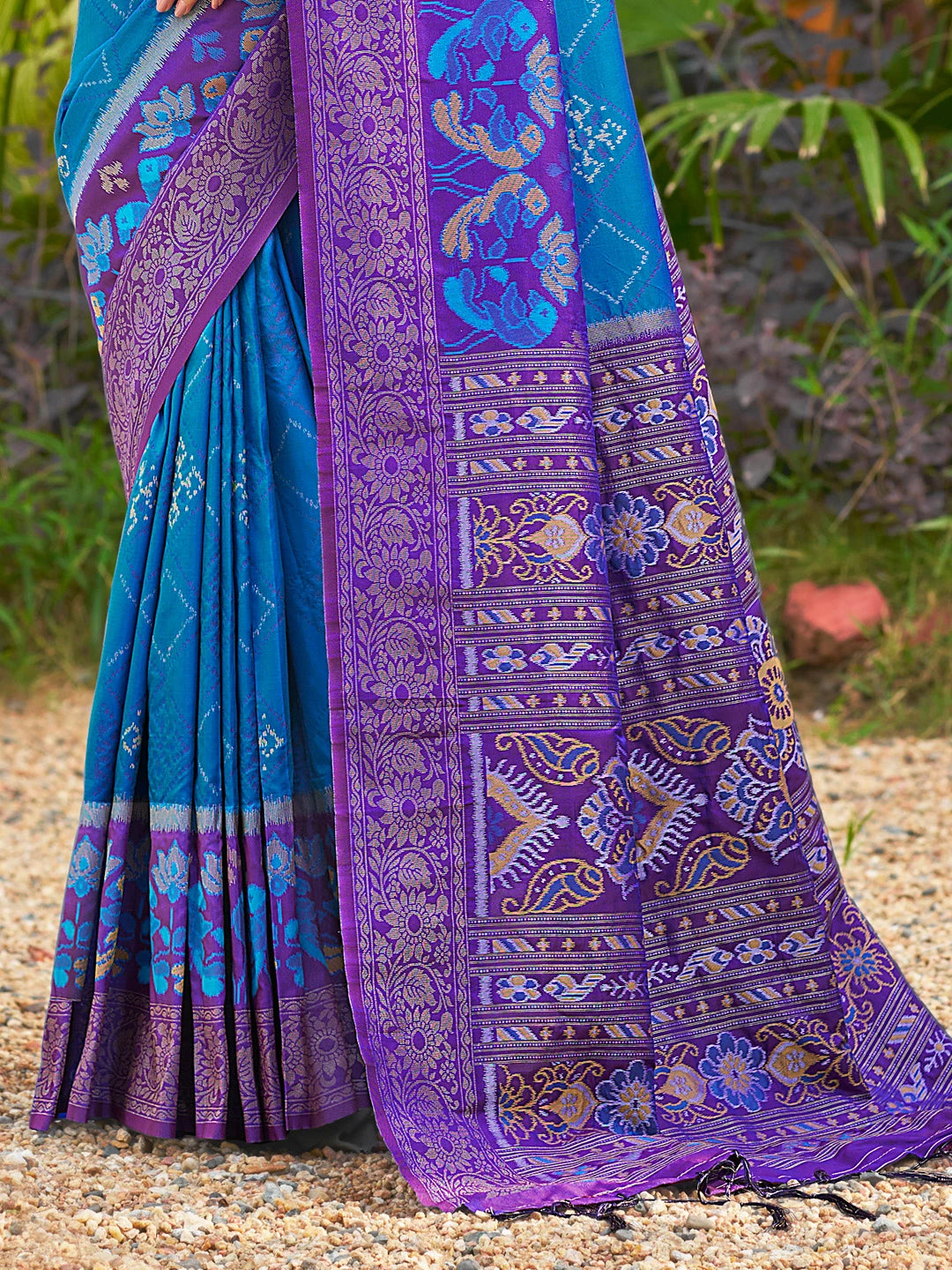Blue and purple saree with intricate patterns on a natural background