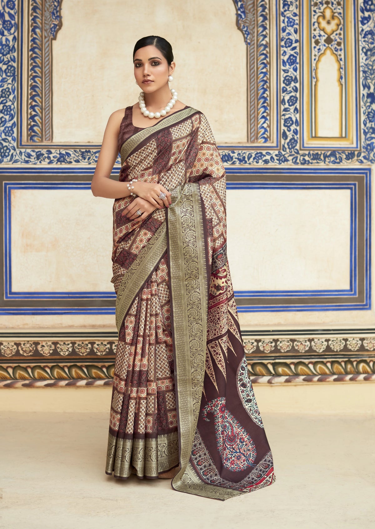 Woman wearing a traditional saree in a decorated room