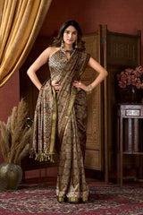 Woman wearing a traditional saree in an elegant indoor setting
