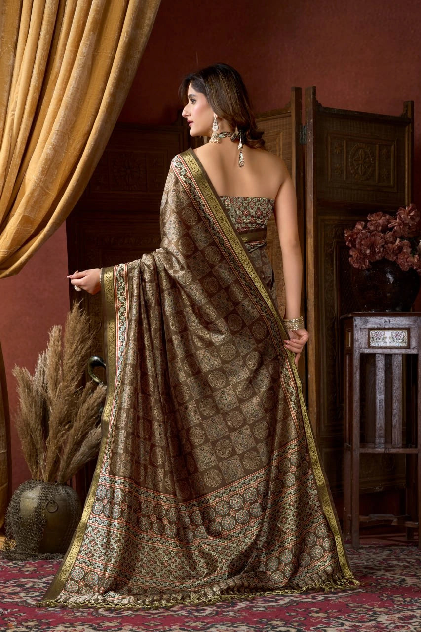 Woman in a traditional saree standing in a room with decorative elements.