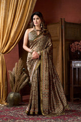 Woman in a traditional saree standing in a room with decorative elements.