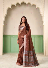 Woman wearing a brown saree with a white border in an archway setting