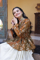 Woman in traditional outfit with floral patterns in a decorated indoor setting