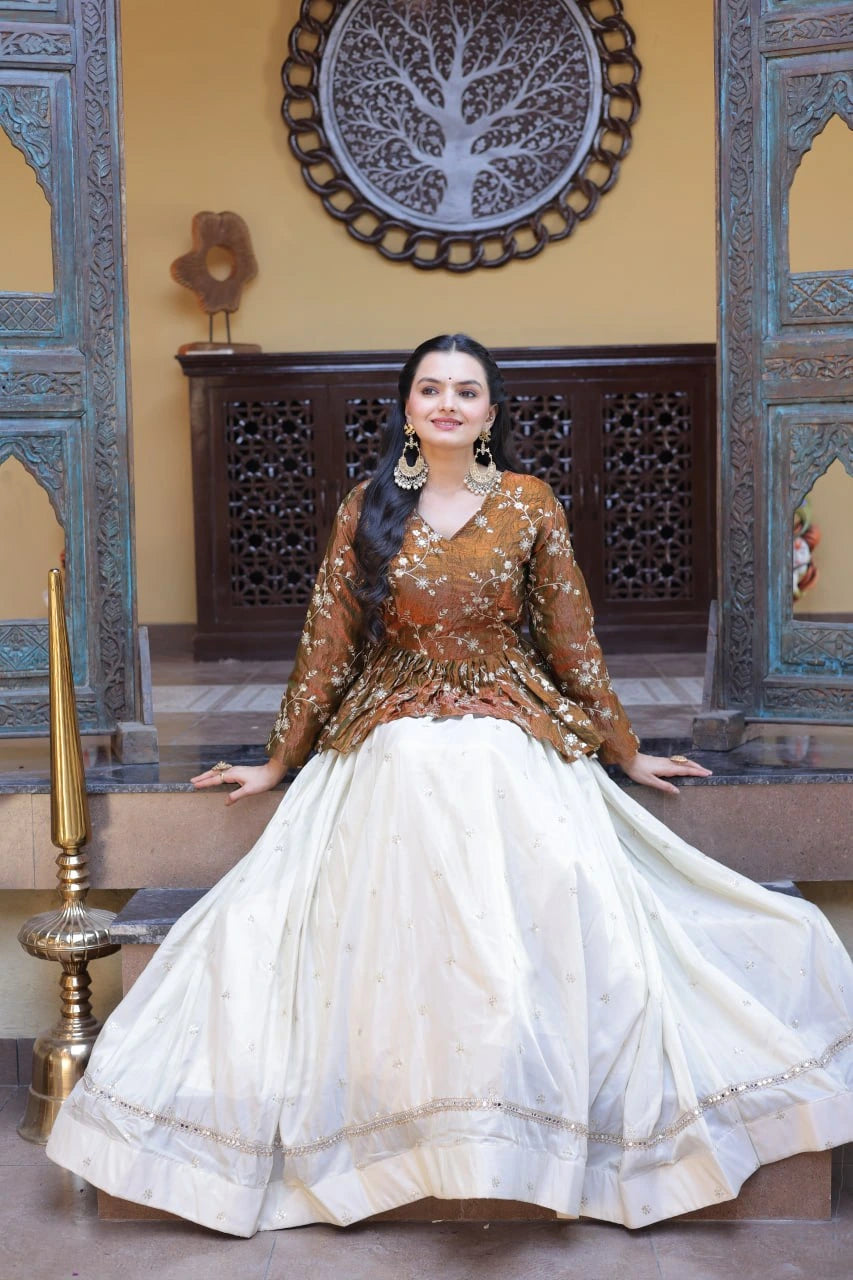 Woman in traditional outfit sitting in a decorative interior setting