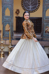 Woman in traditional outfit with intricate design in a decorated room.