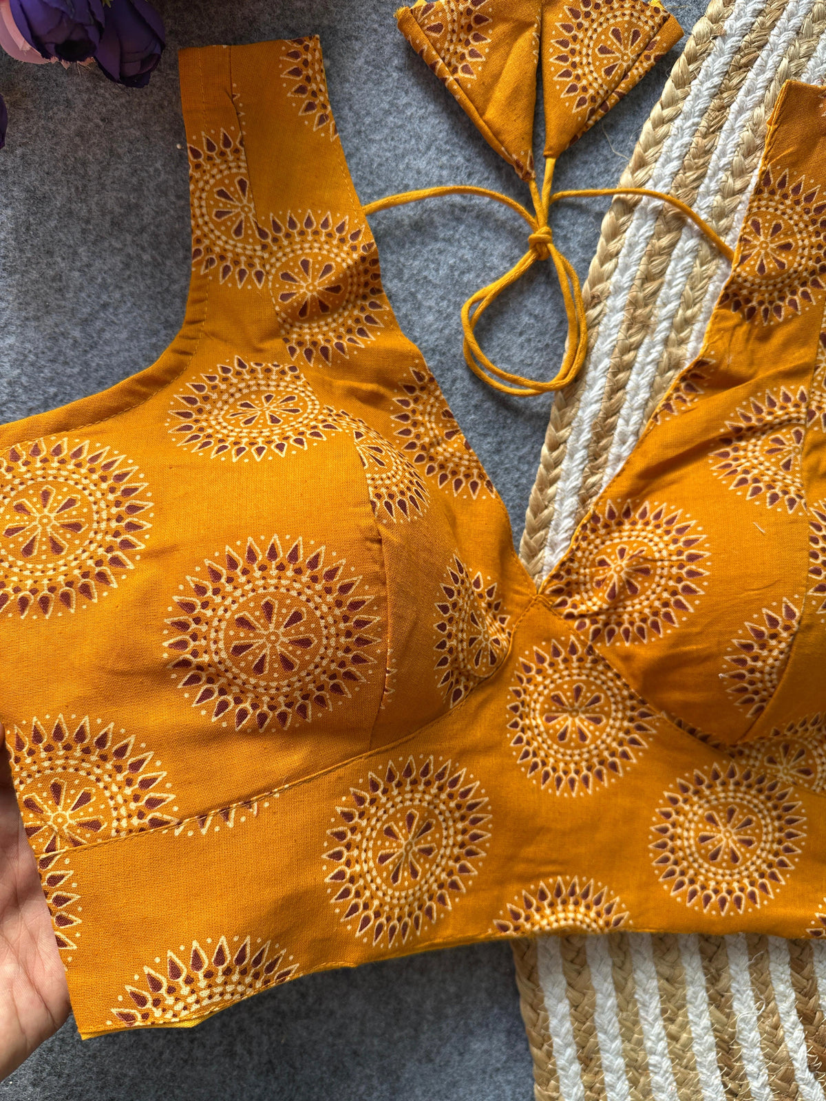 Yellow embroidered top on a textured surface