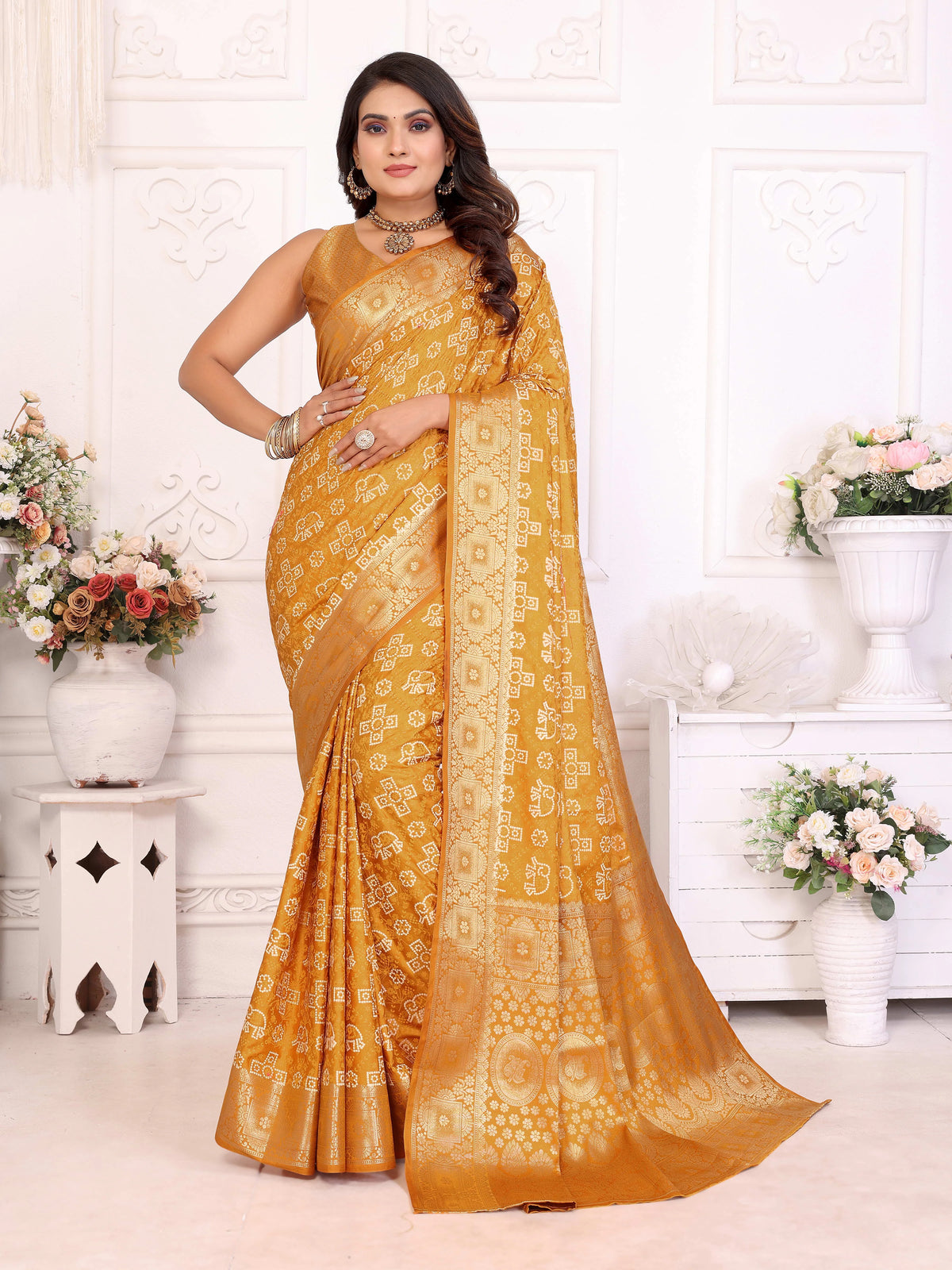 Woman wearing a yellow saree with a white background