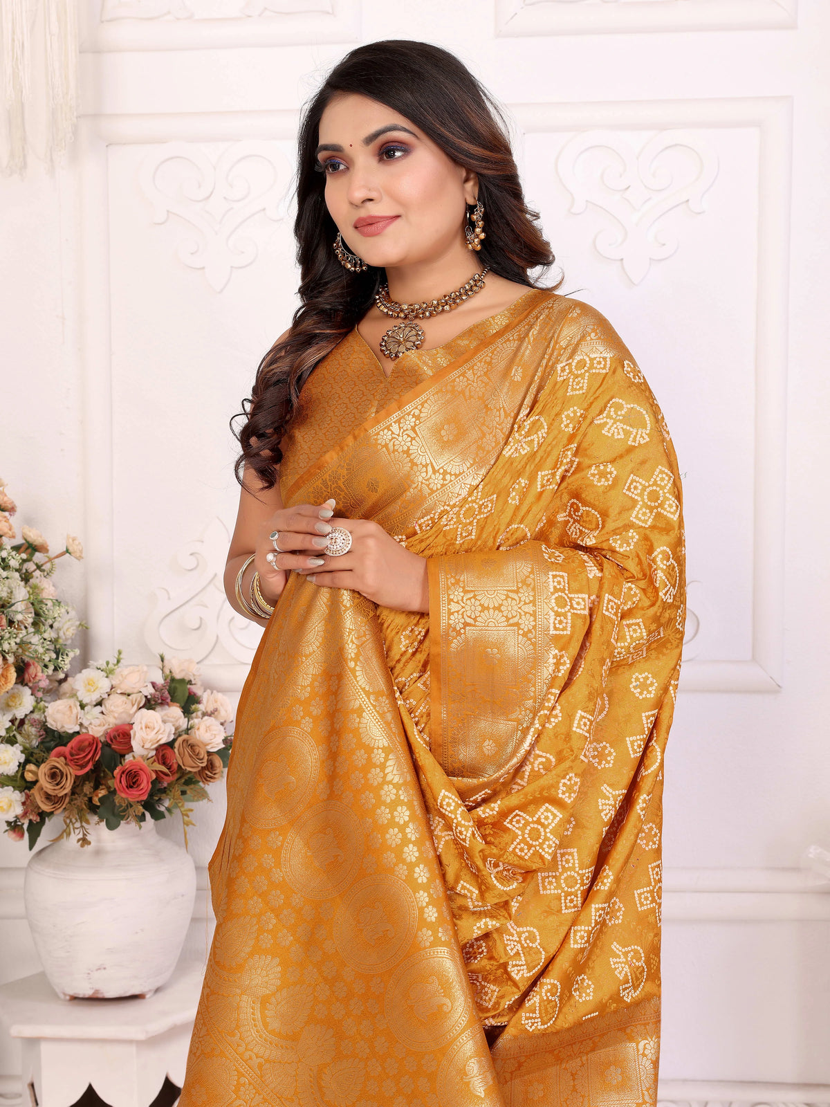 Woman wearing a yellow saree with a white background