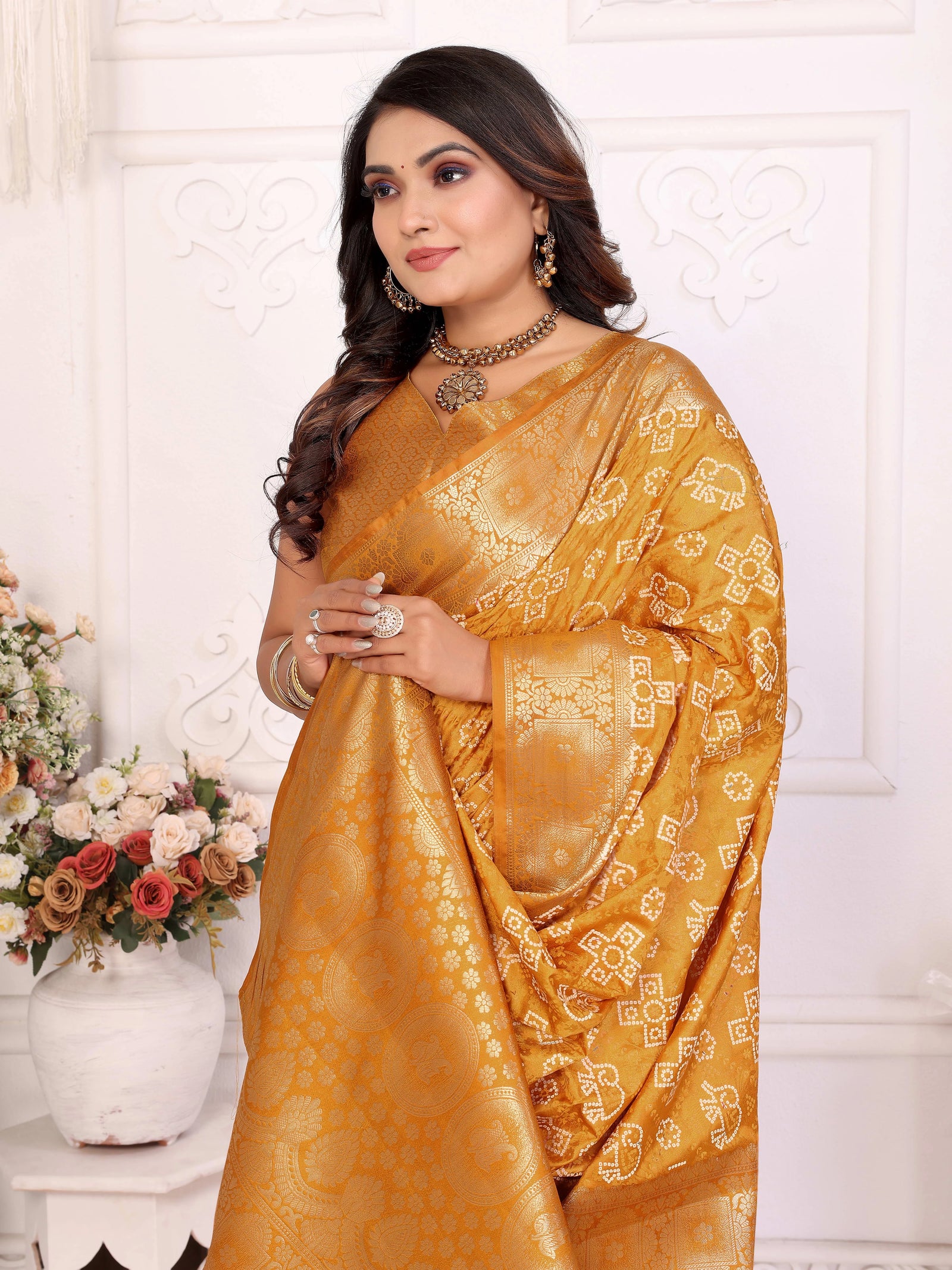 Woman wearing a yellow saree with a white background