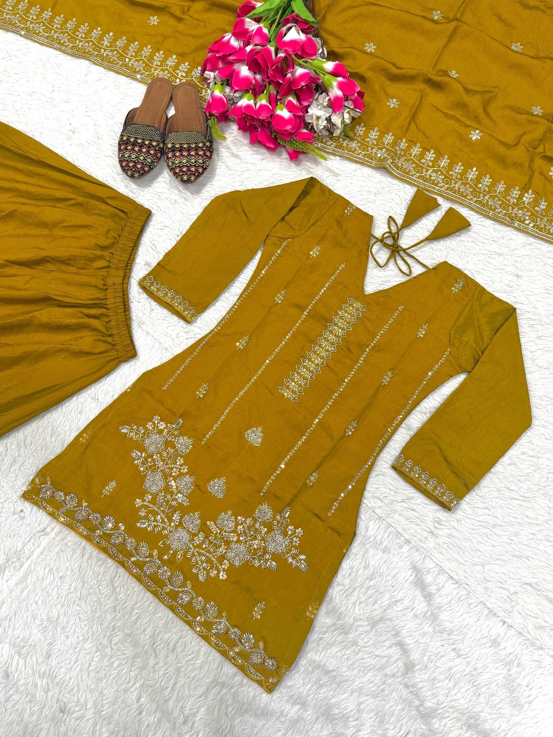 Mustard yellow traditional outfit with floral patterns on a white background