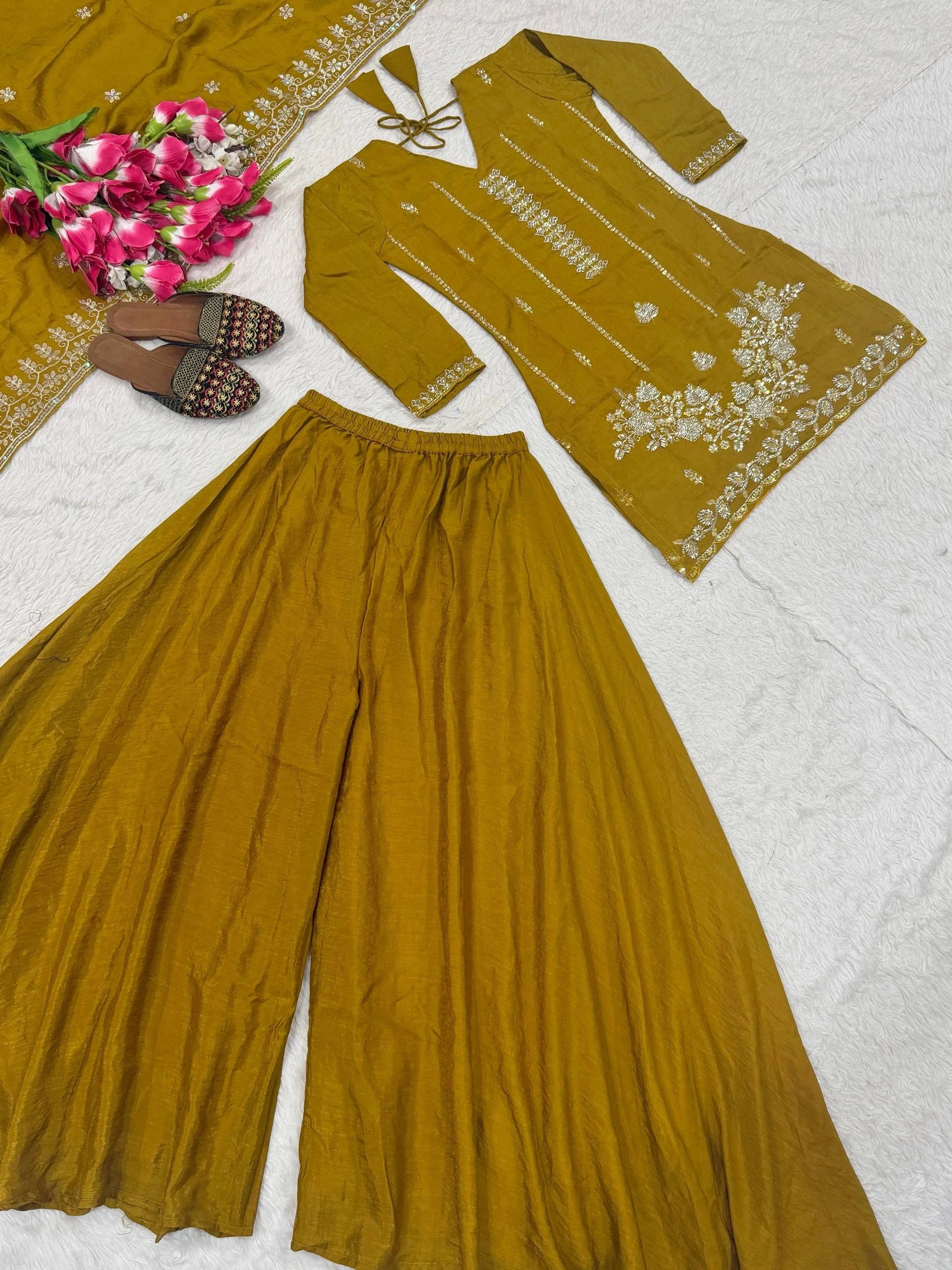 Mustard yellow traditional outfit with floral embroidery on a white background