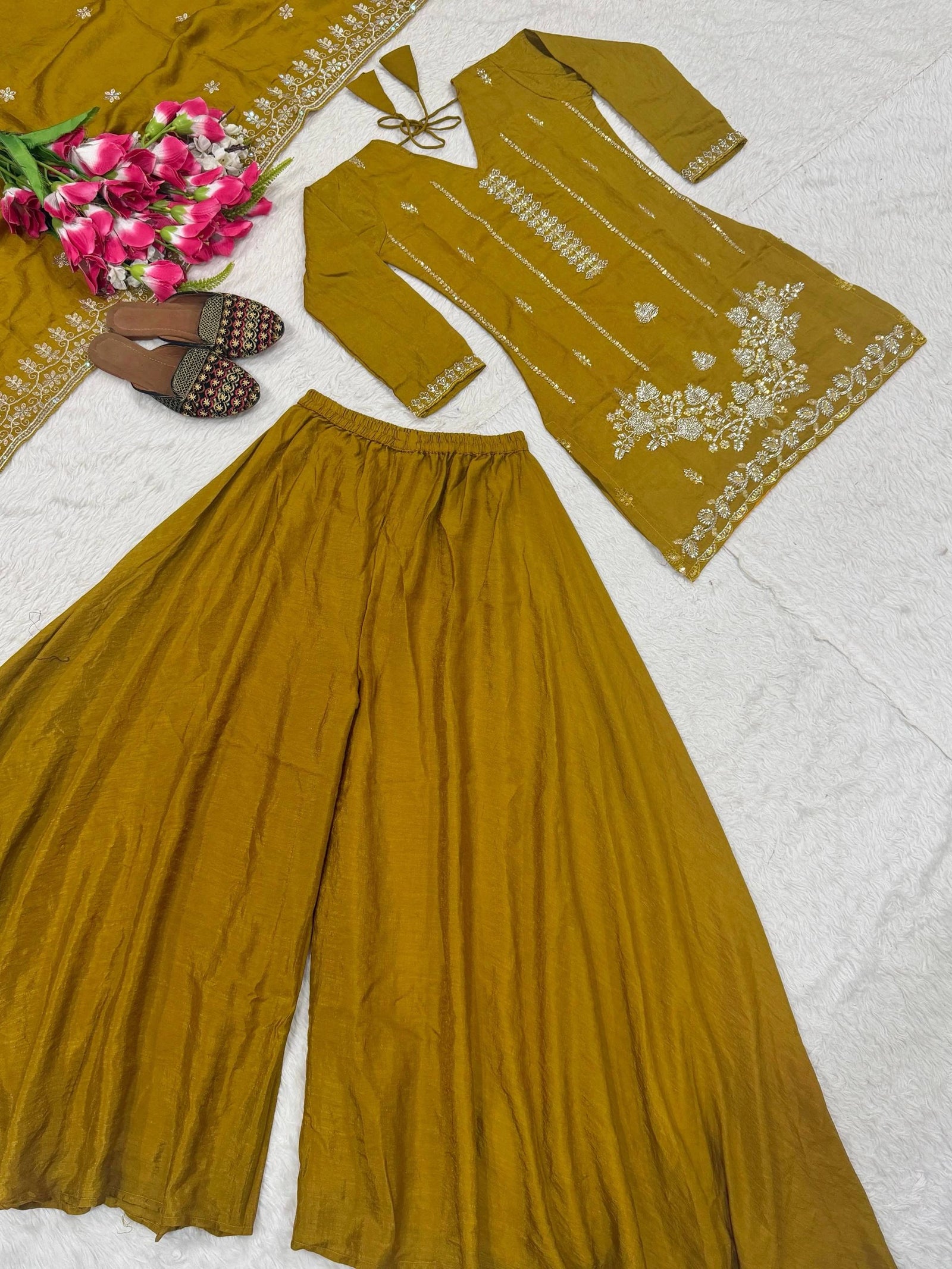 Mustard yellow traditional outfit with floral embroidery on a white background