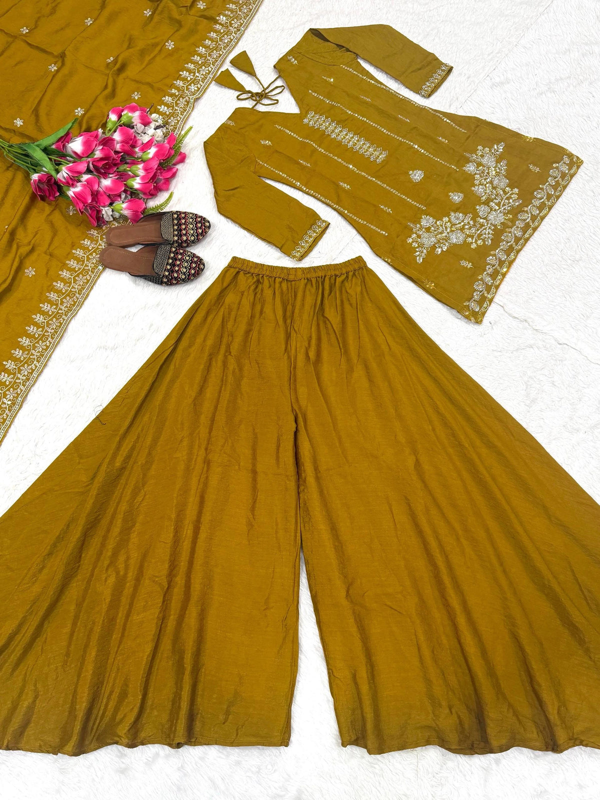 Mustard yellow traditional outfit with floral design on a white background