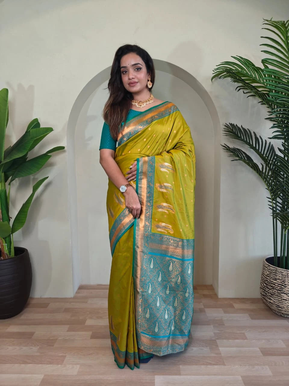 Woman in a yellow saree with a green background