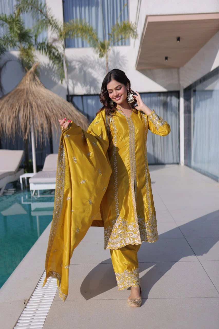 Woman in a yellow traditional outfit standing by a poolside.