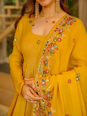 Yellow embroidered traditional outfit with intricate designs on a blurred background