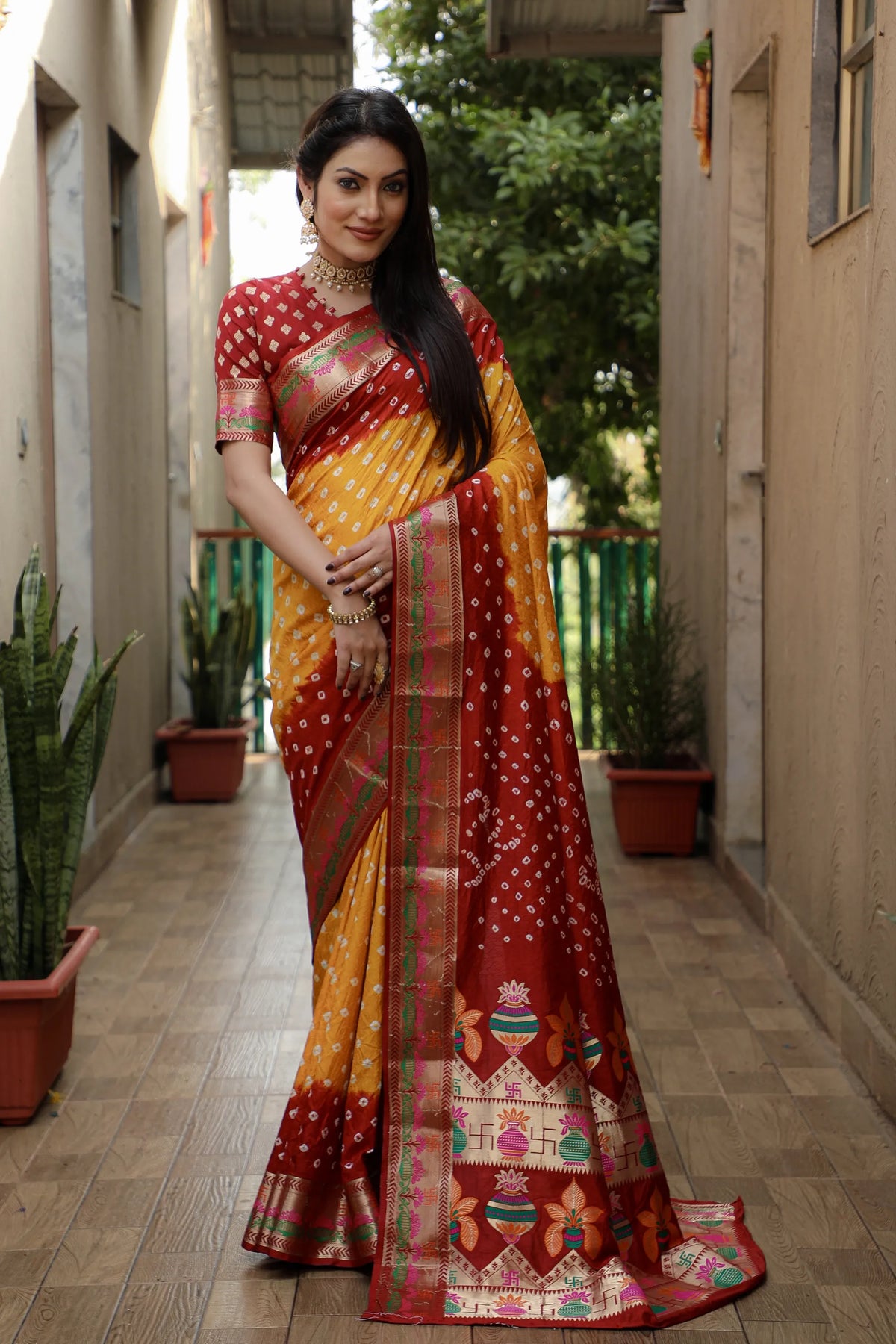 Woman wearing a purple and blue saree with a scenic background