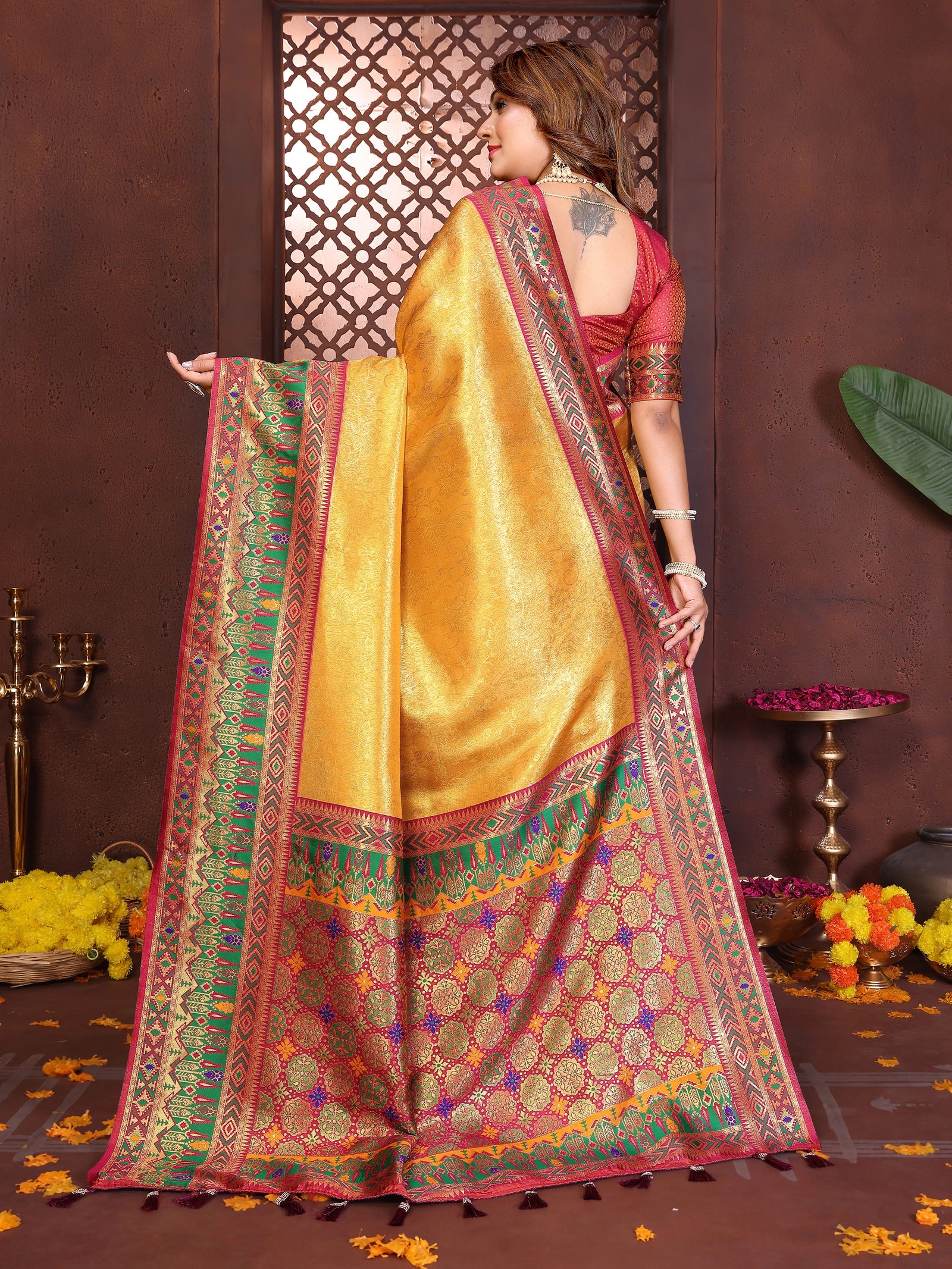 Luxurious soft pure Banarasi tissue silk saree in brown-yellow shade featuring traditional zari patterns.
