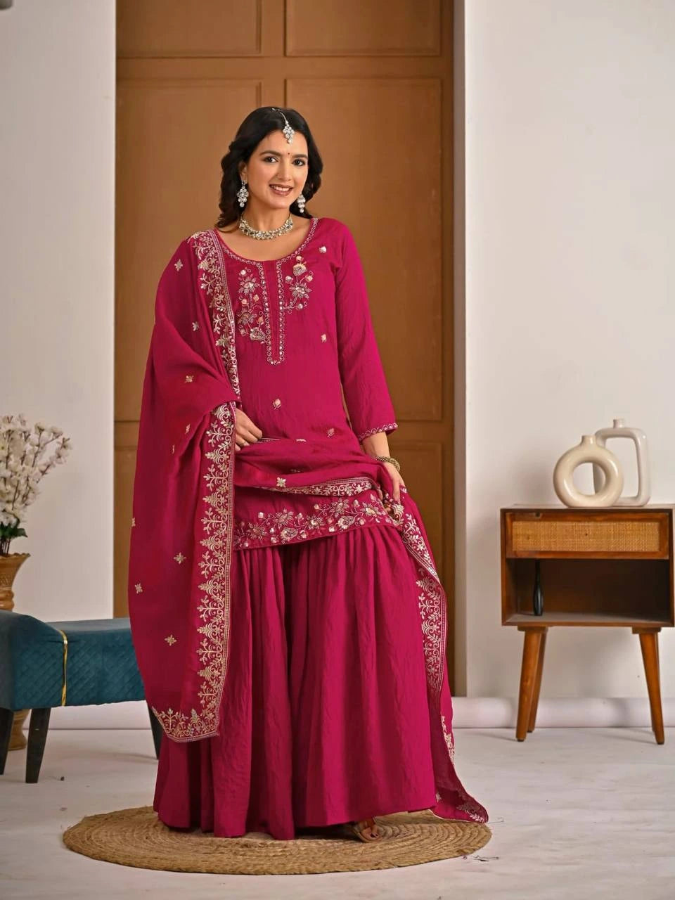 Elegant party wear crimson red embroidered suit with zari weaving craftsmanship.