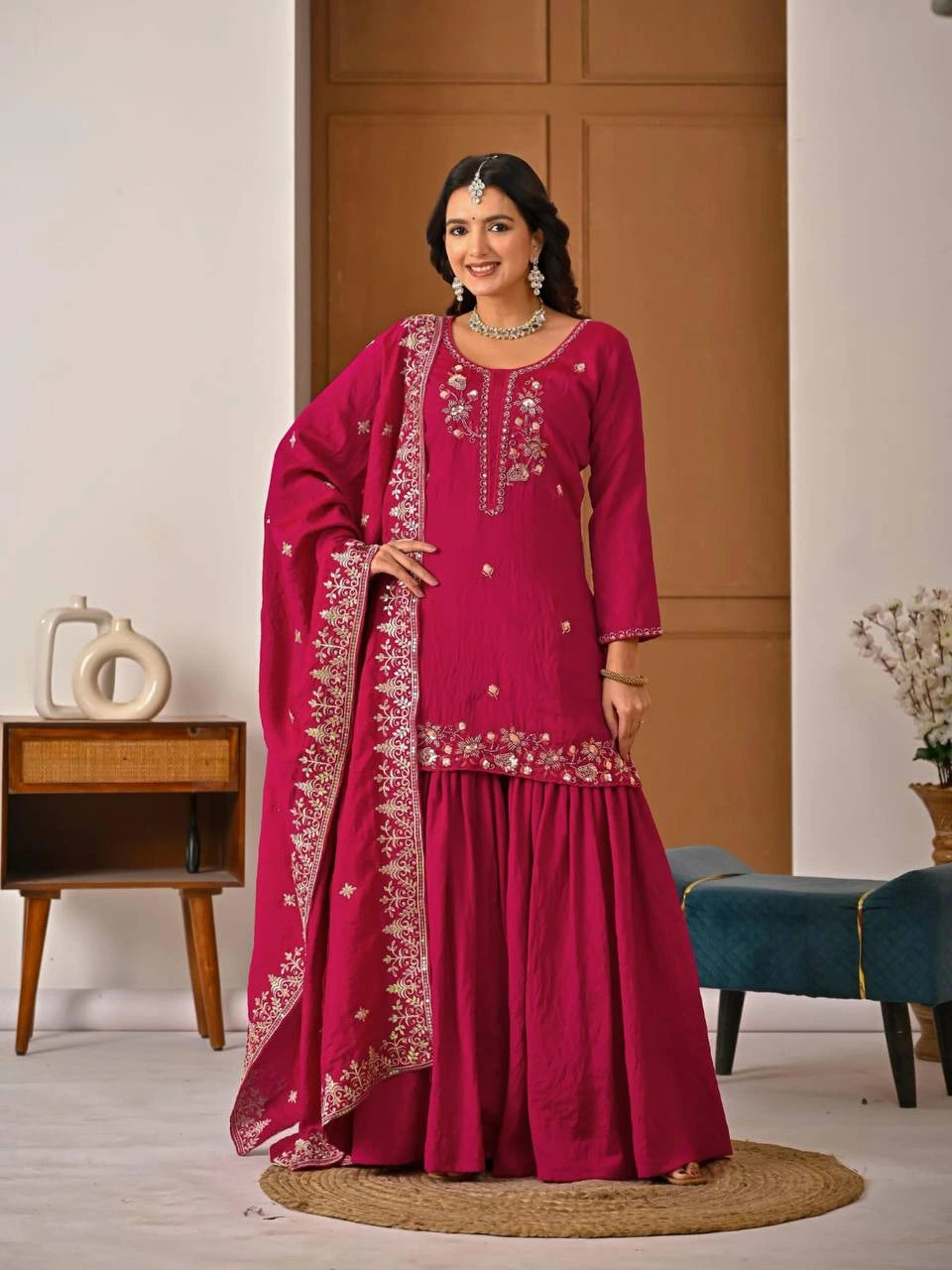 Crimson red Vichitra suit with heavy embroidery and zari weaving displayed on mannequin.