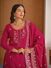 Detailed embroidery patterns on crimson red Vichitra suit fabric for festive wear.