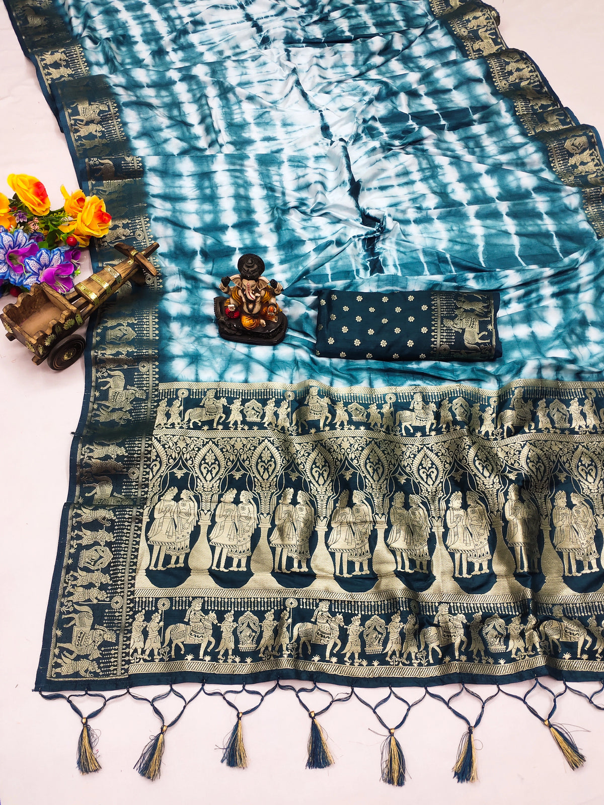 Traditional patterned fabric with tassels on a white background