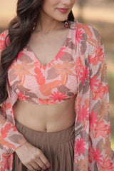 Woman wearing a floral top and beige skirt with a blurred background