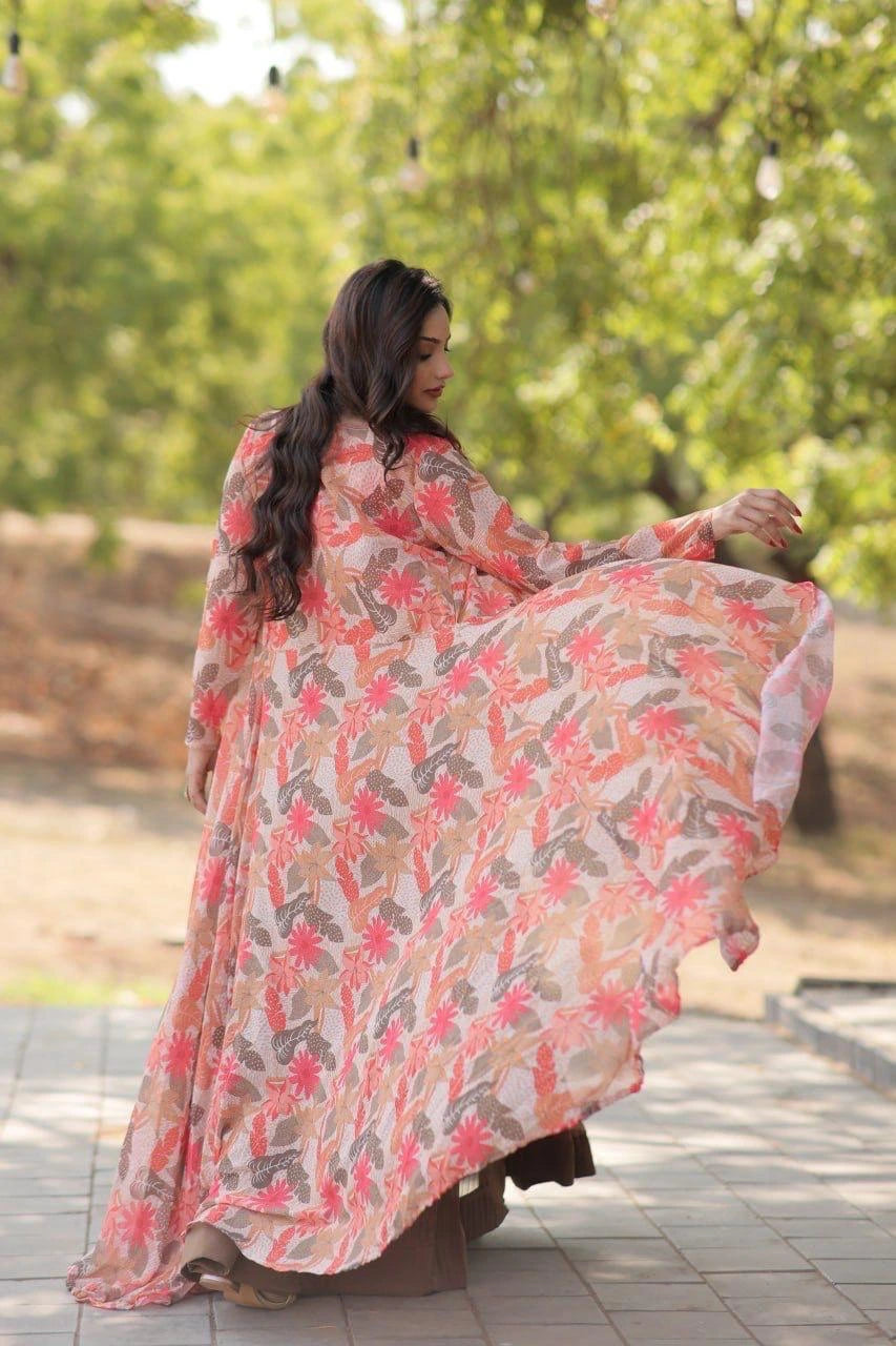 Woman in a floral dress standing outdoors with greenery in the background