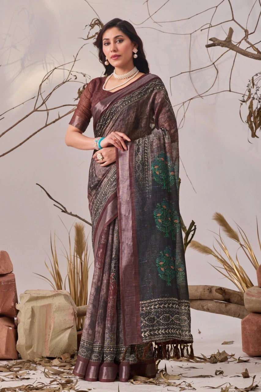 Woman wearing a traditional saree in a natural setting with plants and rocks.