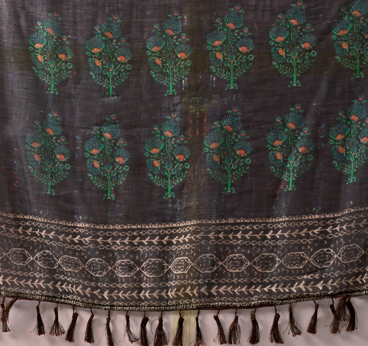 Textile with tree patterns and a decorative border on a white background