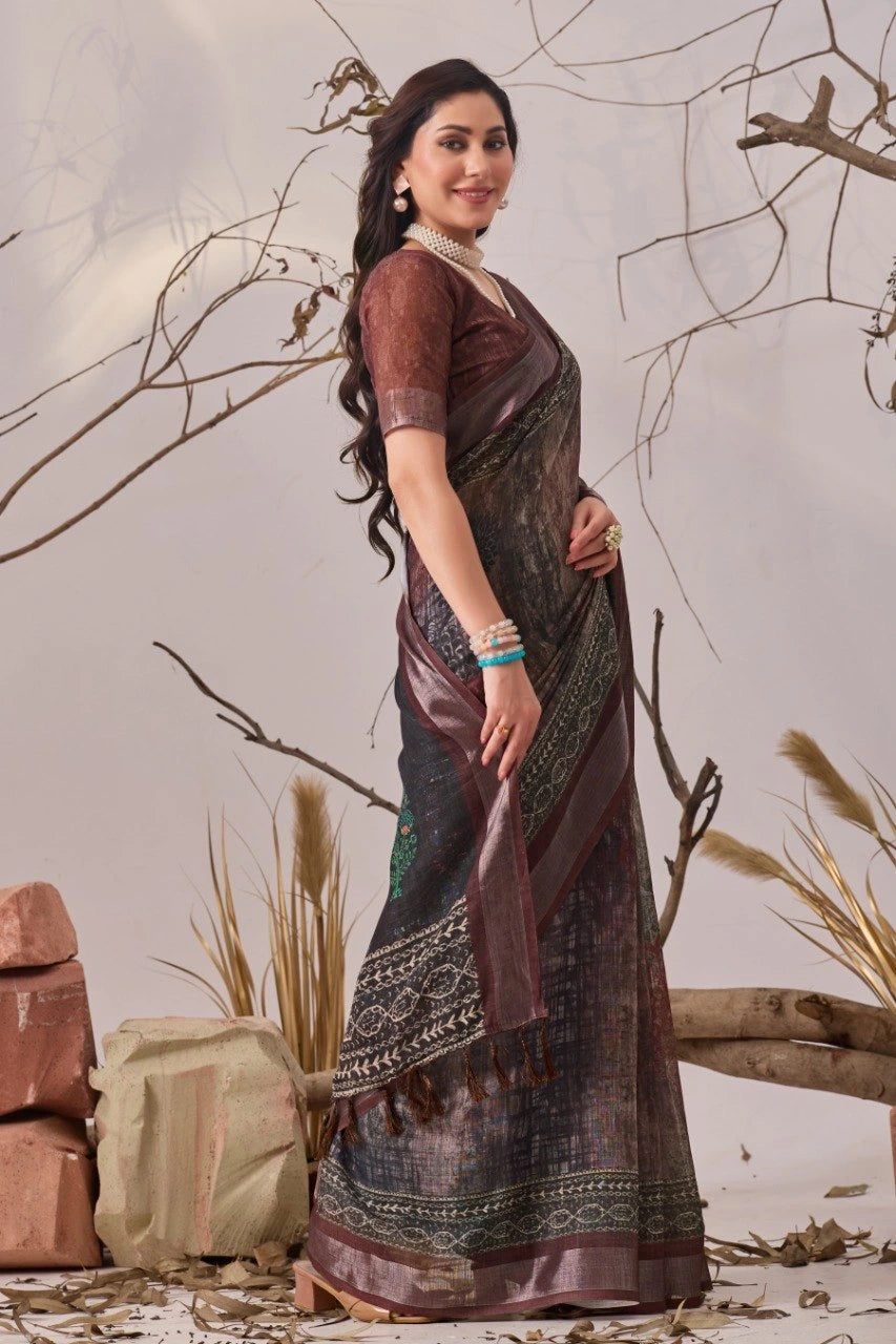 Woman in a traditional saree standing against a neutral background with decorative elements.
