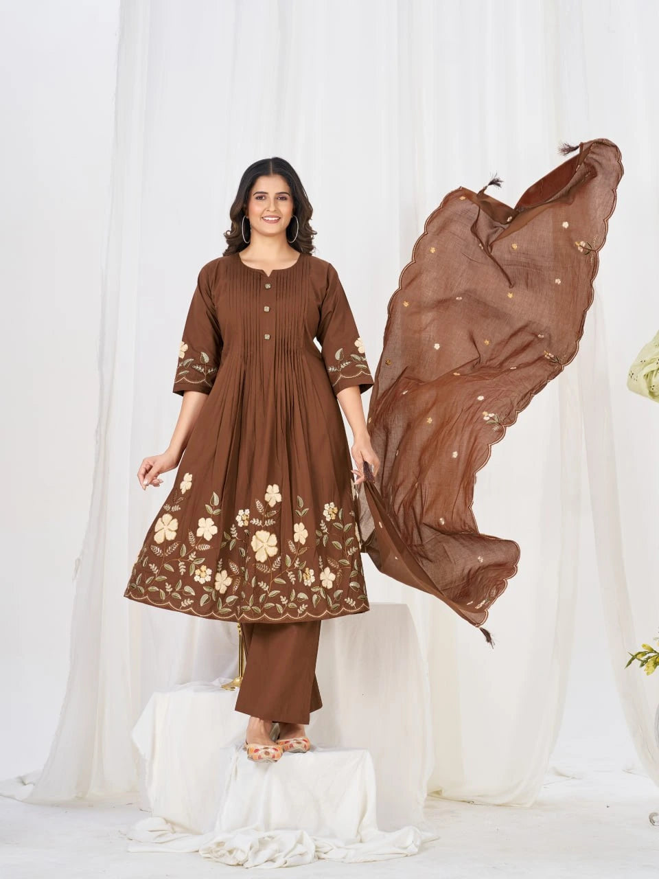 Women's embroidered brown kurta and pant set with delicate floral motifs and a coordinating sheer dupatta for timeless elegance.