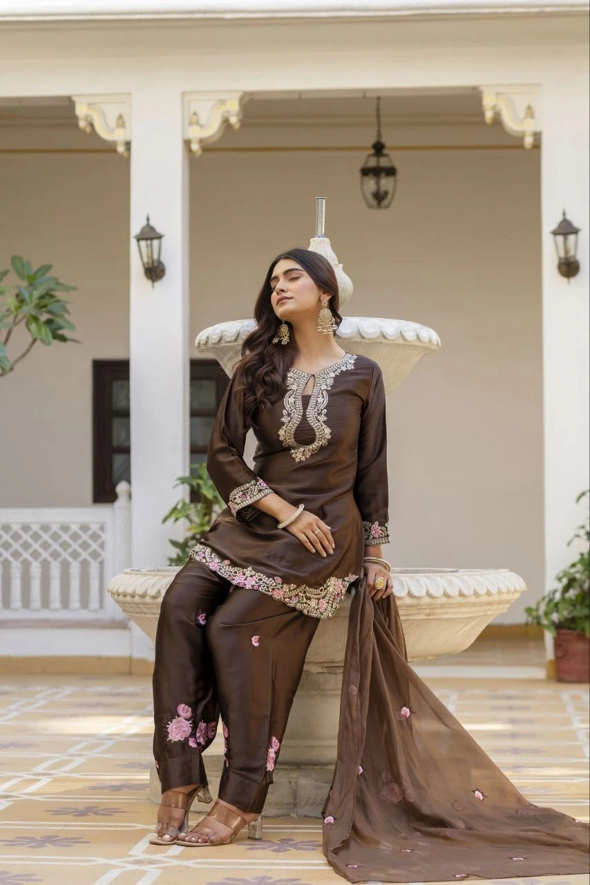 Woman in a traditional outfit sitting on a porch with decorative elements.